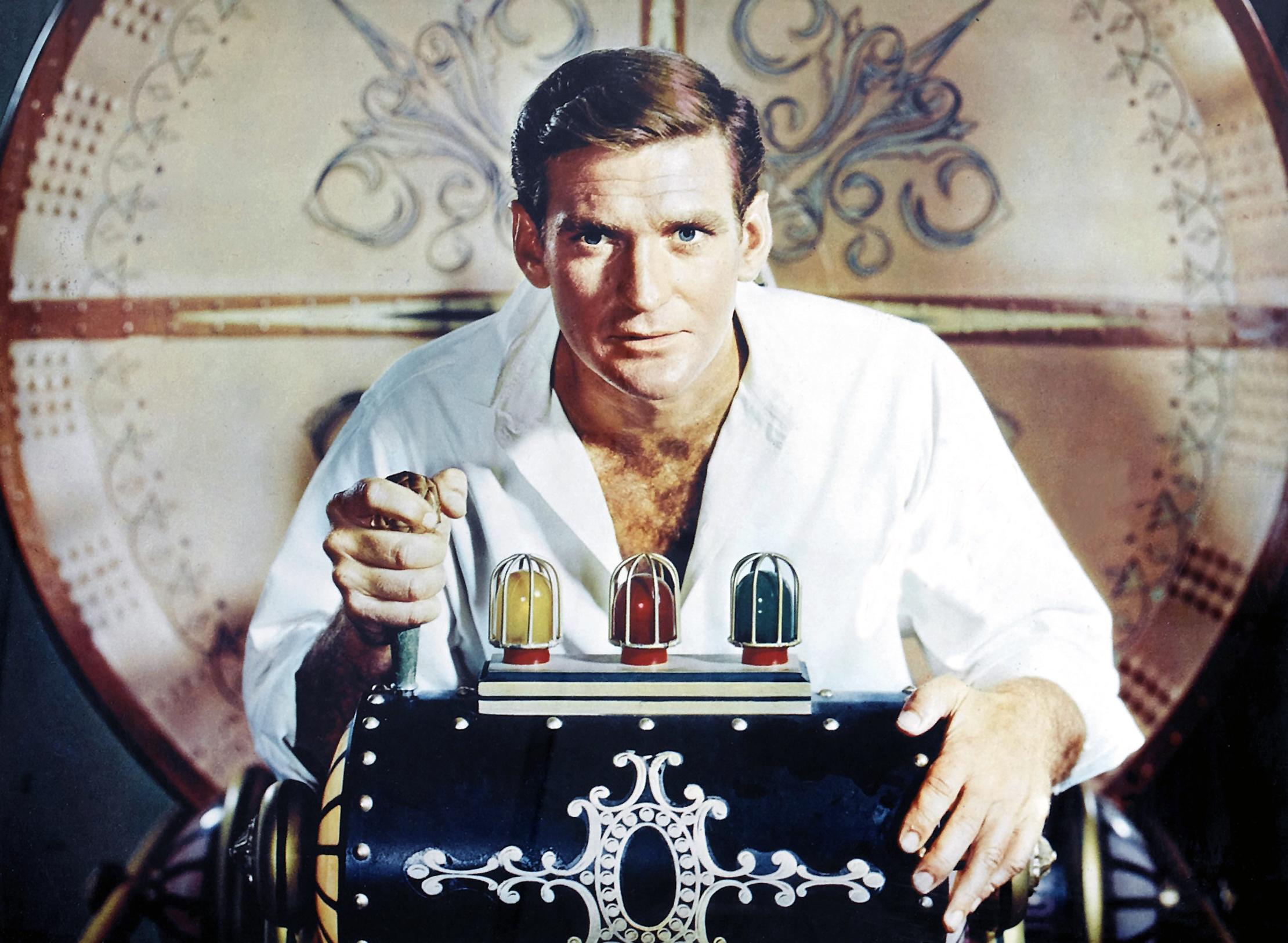 A screenshot of Rod Taylor enthusiastically grabbing a lever on his Time Machine in the 1960 film of the same name