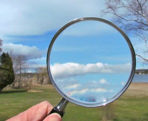 A photograph of clouds under a magnifying glass.